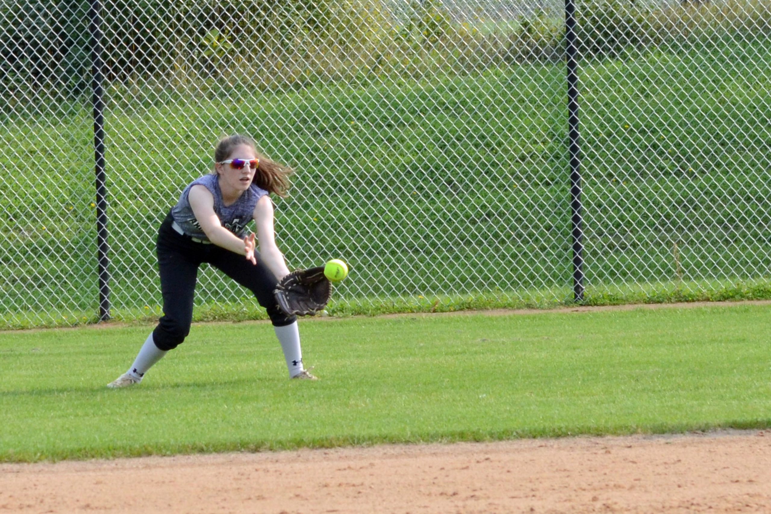 Natalie Black fielding a ball in centerfield